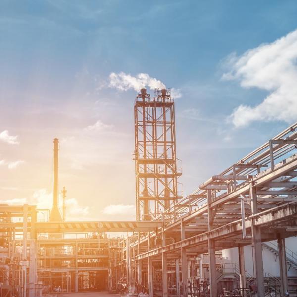 Pipeline and pipe rack of petroleum industrial plant with sunset sky