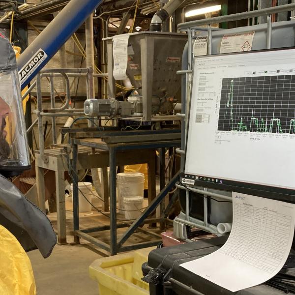 ANSTO Staff member reviewing data on computer screen in Minerals pilot facility