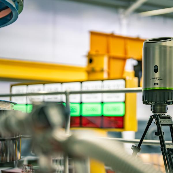 CORIS360 Gamma Neutron Imager unit on tripod in industry setting