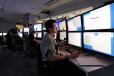 Control room, showing people looking at many computer screens